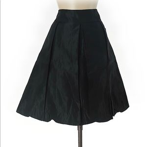Knee length pleated black skirt